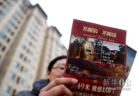 新华社照片，北京，2011年12月11日    “限购令”何去何从？——楼市“限购”一年间    12月11日，一位北京市民在阅读一处地处通州、号称“不限购”的商住两用楼盘广告。 新华社记者罗晓光摄  