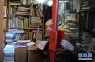 2月19日，在叙利亚首都大马士革，一名书店主人从店内向外张望。新华社记者覃海石摄