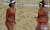 8月1日，薛晨（左）和张希庆祝得分。当日，在伦敦奥运会女子沙滩排球小组赛中，中国选手薛晨/张希以2比0战胜希腊组合阿瓦尼蒂/齐亚尔齐亚尼，顺利晋级。新华社记者格桑达瓦摄
