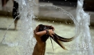8月18日，一名儿童在意大利首都罗马市中心一个喷泉内纳凉。罗马近日遭遇高温天气，周末最高气温预计达到38摄氏度。新华社/法新