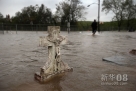 8月29日，在“艾萨克”过境的美国路易斯安那州普拉克明斯教区，洪水淹过一个墓碑。新华社/法新