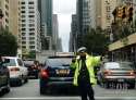 10月31日，在美国纽约曼哈顿第三大道，一名警察在交通信号灯无法工作的路口指挥过往车辆。新华社记者申宏摄