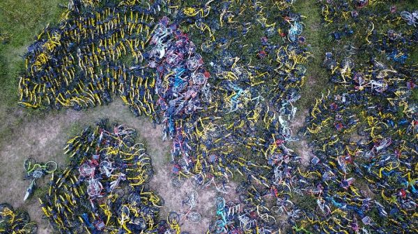 广州市天河区天政街附近的“共享单车坟场”，一块围闭的空地里堆满了废弃的共享单车（无人机拍摄）。 新华社记者李嘉乐摄